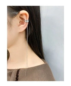 Detail of minimalist S925 silver ear cuff with double ring and long tassel chain drop
