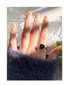 Close-up of S925 silver ring featuring a black heart drop glaze worn on the index finger