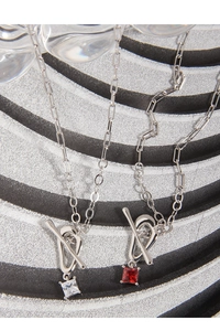 Detail of S925 silver clip chain necklace with square red and white zircon pendants and OT toggle