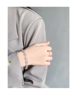 Close-up of S925 sterling silver tennis bracelet with sparkling round-cut cubic zirconia stones