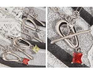 Close-up of S925 silver necklace featuring square cut red zircon and OT buckle detail
