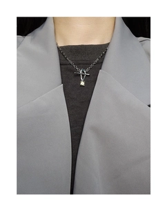 Detail of silver S925 necklace with yellow square zircon pendant on office attire