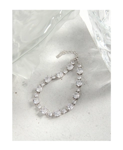 Detail of S925 sterling silver stamp and sparkling zircon stones on women's luxury bracelet