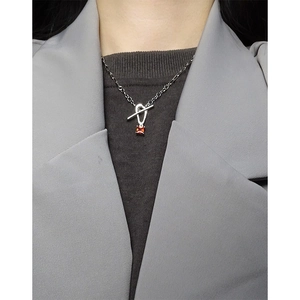 S925 silver OT buckle necklace with red zircon pendant on a model in gray suit