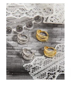 Detail of double-layer S925 sterling silver hoop earrings in gold and silver finishes