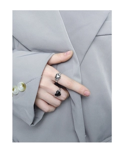 Gros plan détaillé d'une bague cœur en argent S925 avec texture métal liquide et gemme
