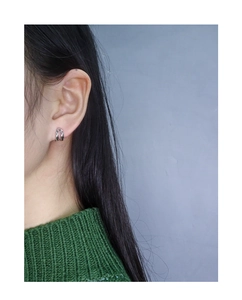 Close-up of minimalist S925 sterling silver double hoop earrings worn on a model
