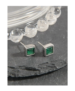 Macro shot of S925 silver stud earrings with square emerald-cut green zirconia stones