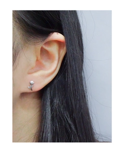 Gros plan de boucles d'oreilles tulipe en argent S925 avec perles sur l'oreille