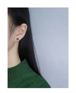 Detailed close-up of geometric square emerald zircon stud earrings in S925 sterling silver
