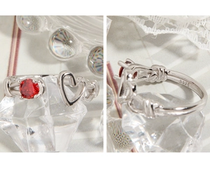 Detailed macro view of S925 sterling silver heart ring with red zircon stone inlay