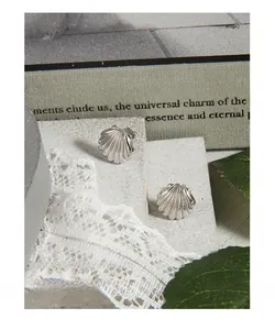 Macro shot of S925 sterling silver seashell studs with fine texture on stone