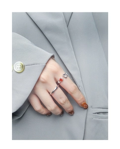 Close-up of S925 silver ring set featuring a red zircon gemstone and hollow heart design