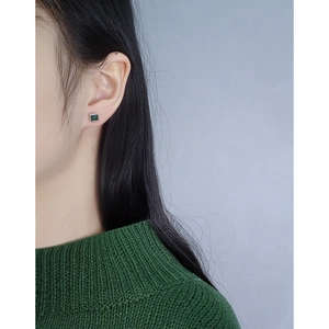Minimalist S925 silver stud earrings with emerald zircon on a female model