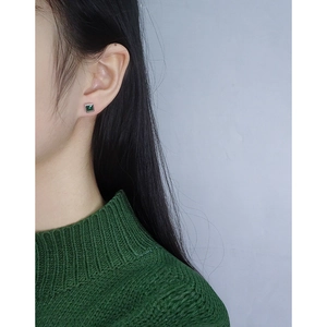 Elegant 925 silver square emerald zircon stud earrings worn by a model on the ear