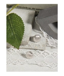 Macro detail of S925 sterling silver shell earrings with textured metallic finish