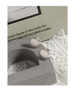 Macro view of S925 sterling silver shell stud earrings showing delicate texture details
