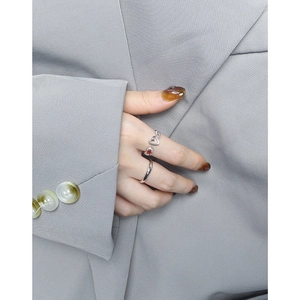 Minimalist S925 sterling silver heart ring set with red zircon stone on a female hand