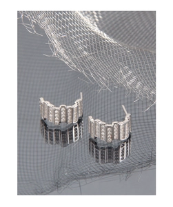 Macro shot of silver C-shaped hoop earrings with micro-pave cubic zirconia inlay