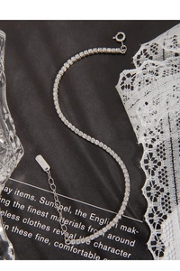 Macro detail of S925 sterling silver tennis bracelet with shimmering round crystals
