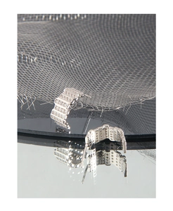 Detail of silver geometric earrings featuring micro-pave cubic zirconia on black surface