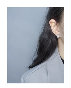 Close-up of elegant S925 silver rectangle earrings with pavé zircon worn by a model
