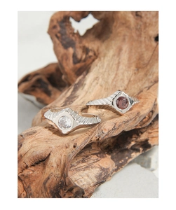 Macro detail of geometric S925 silver rings with micro-set zircon and engraved texture