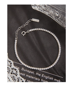 Close-up of S925 sterling silver tennis bracelet with adjustable clasp on black satin
