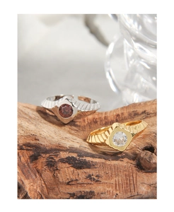 Detail of vintage geometric rings with micro-set zircon and brushed metal texture