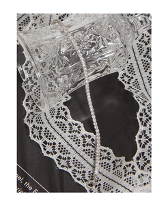Detailed macro view of S925 silver tennis bracelet with sparkling zircon on lace background