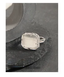 Macro detail of S925 silver ring featuring a square cat-eye stone and lava texture finish