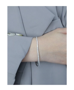 Detailed close-up of a shimmering S925 silver tennis bracelet with cubic zirconia