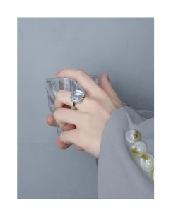 Detail of silver S925 ring featuring a large square grey crystal on a model hand