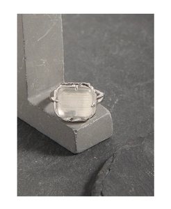 Detailed close-up of S925 silver ring featuring a square crystal and textured band