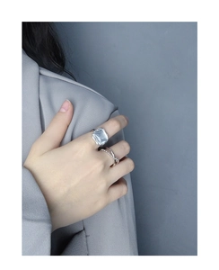 Detail of silver S925 rings featuring a large square light blue crystal on hand