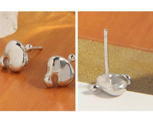 Macro shot of S925 sterling silver geometric earrings featuring the engraved purity stamp
