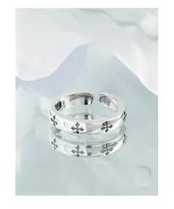 Close-up of S925 silver ring featuring vintage black cross embossing and punk style detail