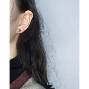 Minimalist S925 sterling silver geometric heart stud earring worn by a model