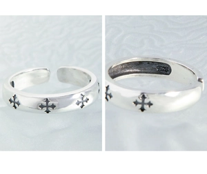 Detailed macro view of S925 sterling silver ring with black cross patterns and hallmarking