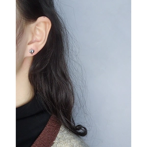 Polished S925 sterling silver geometric jigsaw stud earrings worn by a model