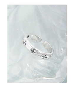 Macro shot of silver S925 cross pattern ring with vintage chrome style on frosted glass