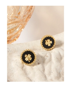 Macro shot of S925 silver four-leaf clover stud earrings with black enamel inlay