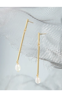 Macro detail of S925 silver long drop earrings with gold rod and white natural pearl