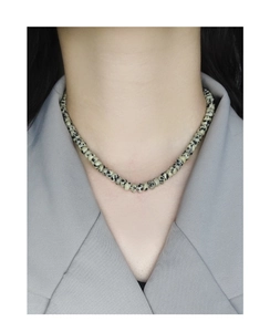 Close-up of S925 silver leopard spot jade bead necklace on model with grey suit