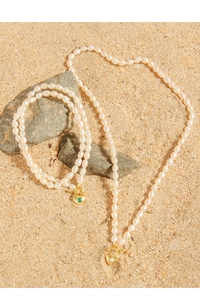 Macro shot of S925 silver pearl necklace with gold heart charm and OT toggle clasp