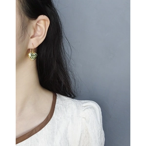 Minimalist S925 silver 3D heart drop earrings in gold finish worn by a model