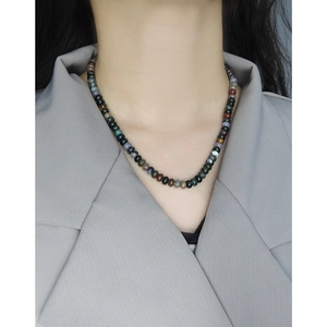 Chic multi-color agate stone beaded necklace worn by a model in a grey blazer