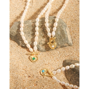Elegant S925 silver pearl heart necklace with OT clasp shown in natural outdoor light