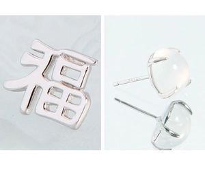 Macro detail of S925 sterling silver earring with Fu character and moonstone inlay