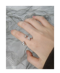 Detail of silver S925 liquid-style ring with bubble texture on metal mesh background